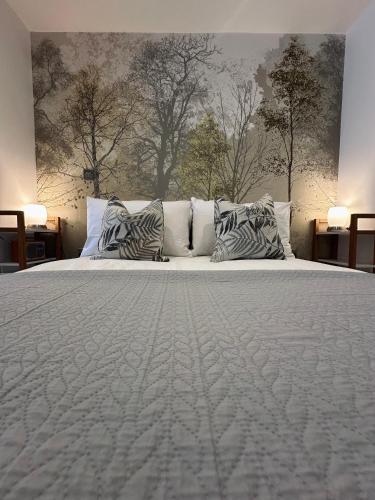 a bedroom with a large white bed with pillows at Botanical Suite Ryde Isle of Wight in Isle of Wight