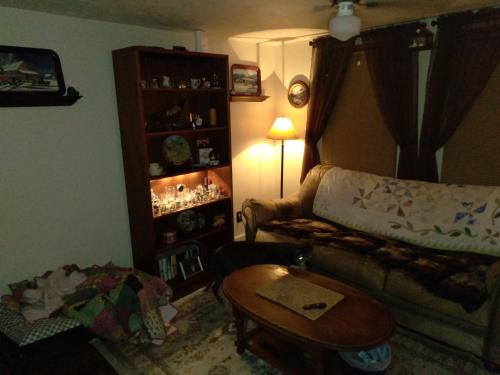 a living room with a couch and a table at Cozy 2 Bedroom Home in Madison