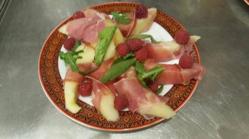 a plate of food with meat and berries on it at Villa Sosnovy Bor in Zatoka