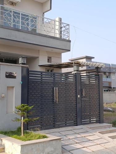 a black fence in front of a house at RMT Residencia per room in Peshawar