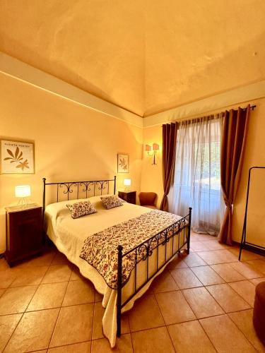 a bedroom with a bed and a window with curtains at Casa dell'Edera T in Orvieto