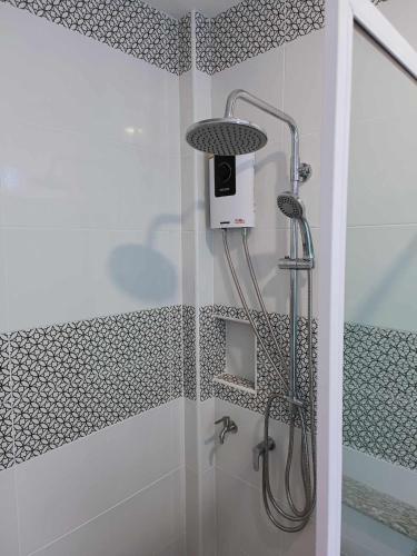 a shower with a shower head in a bathroom at รักเขาแอนด์บ้านมุง in Ban Mung