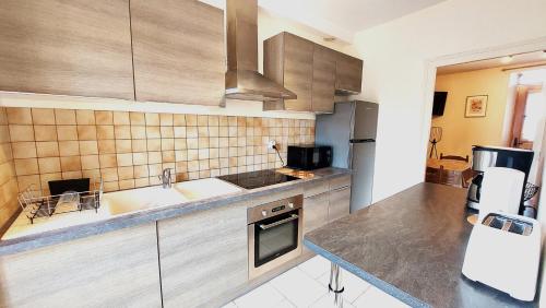 a kitchen with a sink and a counter top at Maison centre ville in Nogent-sur-Vernisson