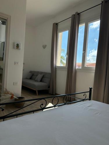 a bedroom with a bed and a large mirror at Marina Casa Vacanza in Capoterra