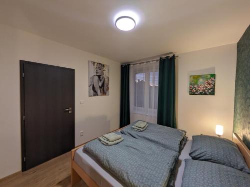 a small bedroom with a bed and a window at Apartmány U Lazara in Kutná Hora