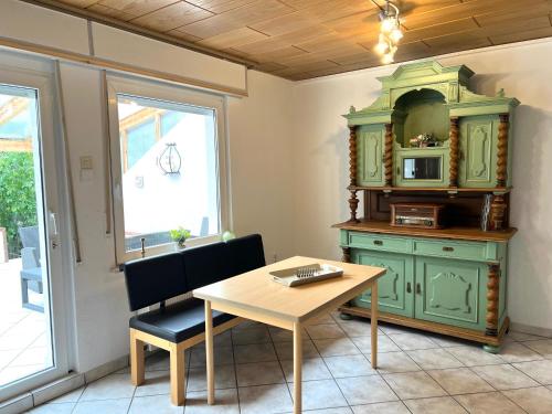 a dining room with a table and a microwave at Kurpark Ferienwohnung in Schleiden