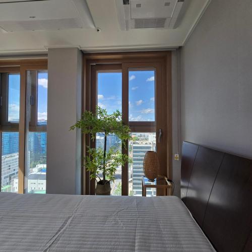una camera da letto con un letto e una grande finestra di 원스테이 가산디지털단지 a Seul