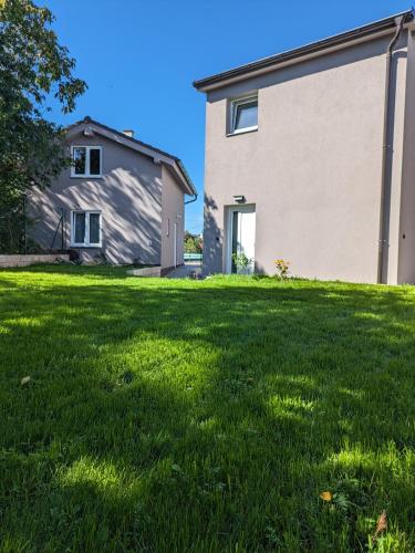 a grassy yard with a house in the background at Apartmány U Lazara in Kutná Hora