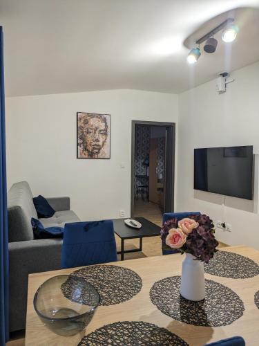 a living room with a table and a couch at Apartmány U Lazara in Kutná Hora