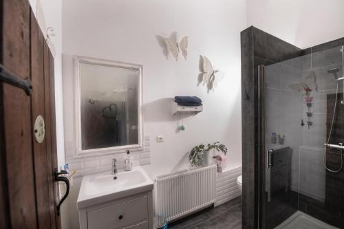 a white bathroom with a sink and a shower at Villa Souvenir, Lenax in Lenax