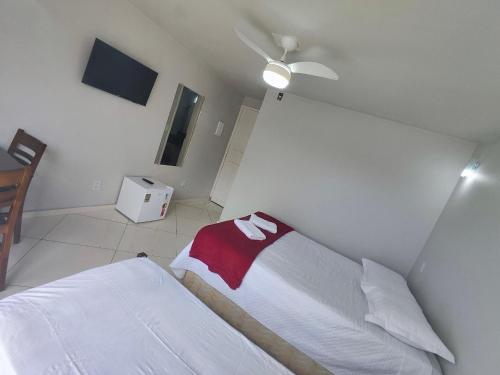 a bedroom with a bed and a ceiling fan at Hotel Estação in Diamantina