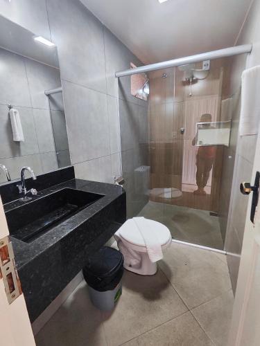 a bathroom with a sink and a toilet and a shower at Hotel Estação in Diamantina