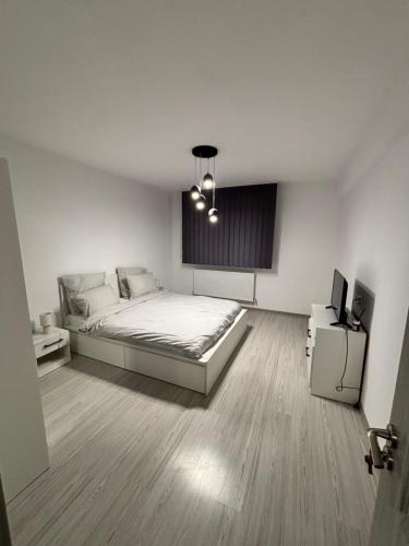a bedroom with a bed and a television in it at Cozy Nest in Constanţa