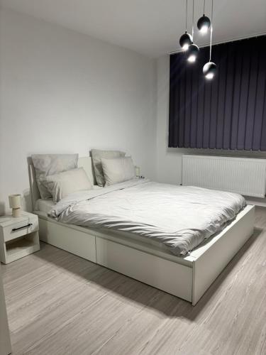 a white bedroom with a large bed in it at Cozy Nest in Constanţa