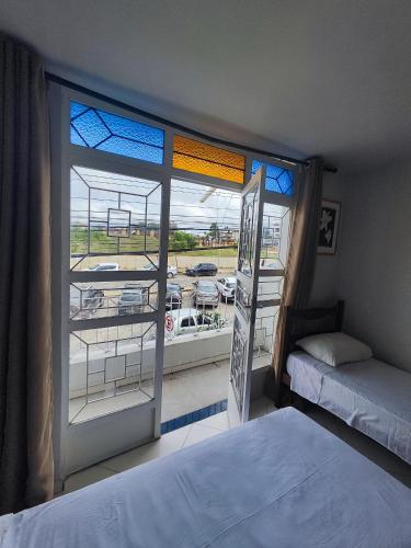 a bedroom with a window with a view of a parking lot at Hotel Estação in Diamantina