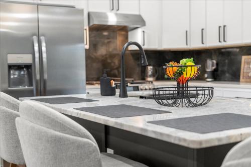 a kitchen with a counter with a bowl of fruit at Spacious 3BR 3BA Home Modern Renovation in Decatur