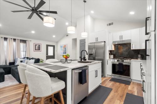 a kitchen with white cabinets and a table with chairs at Spacious 3BR 3BA Home Modern Renovation in Decatur