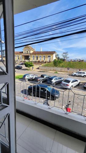 a window with cars parked in a parking lot at Hotel Estação in Diamantina