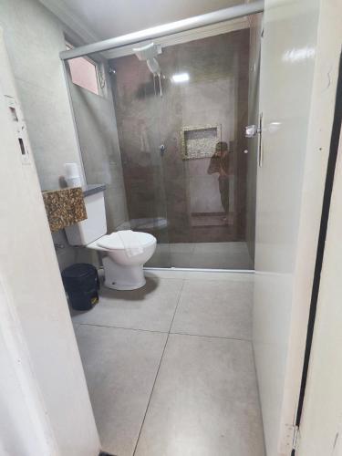 a bathroom with a toilet and a glass shower at Hotel Estação in Diamantina