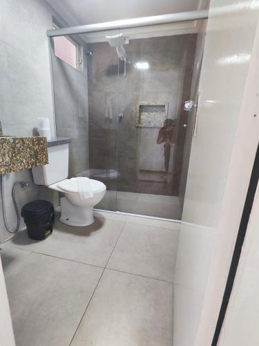 a bathroom with a toilet and a glass shower at Hotel Estação in Diamantina