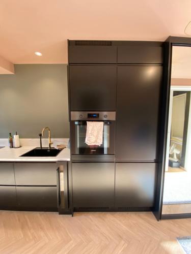 a kitchen with a stainless steel refrigerator and a sink at Nice and modern apartment in Stavanger