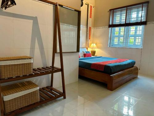 a bedroom with a bed and a shelf in it at Chang's Hideaway homestay ConDao in Con Dao