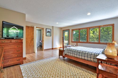 a bedroom with a bed and a flat screen tv at 4BR Killington Home Perfect for Families, Pet-Friendly, Fireplace in North Sherburne