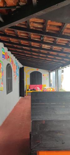 a room with a room with a bed on the wall at Espacio chill hostel in Búzios
