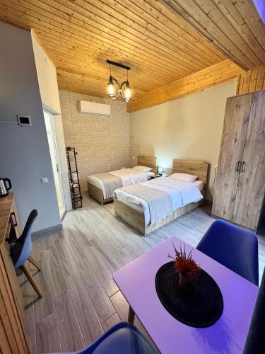 a room with two beds and a table and chairs at Sairme Glampings in Sairme