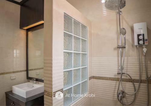 a bathroom with a shower and a sink and a mirror at Nadia 2 Ao Nang Pool Villa in Ban Chong Phli