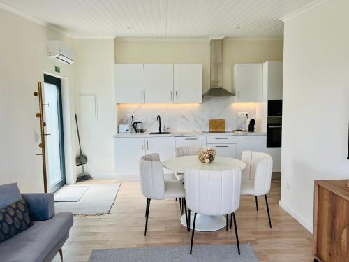 a kitchen and dining room with a table and chairs at Vila Pombal Tomar Apartments - Pool & City Views in Tomar