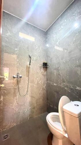 a bathroom with a shower and a toilet at Tegala Home in Payangan