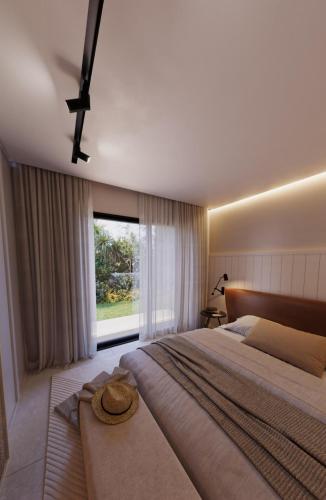 a bedroom with a large bed and a large window at Villa Golfinho Luxury in Praia do Carvoeiro