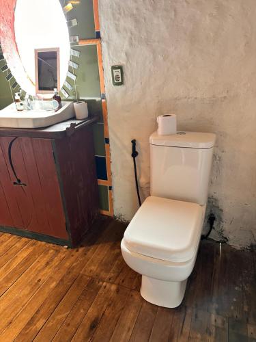 a bathroom with a white toilet and a sink at Casa grande Los Manzanos in Aiguá