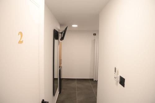 a hallway with white walls and a door at Puy Castele Hotel Tiberias in Tiberias