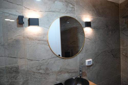 a bathroom with a mirror and a sink at Puy Castele Hotel Tiberias in Tiberias