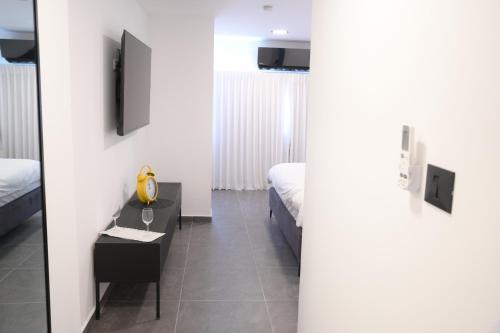 a room with two beds and a table with a mirror at Puy Castele Hotel Tiberias in Tiberias