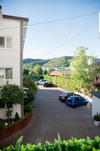 a parking lot with two cars parked in it at Pensiunea Paradis in Râmnicu Vâlcea