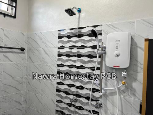 a bathroom with a black and white striped wall at Nawra Homestay PCB in Kota Bharu