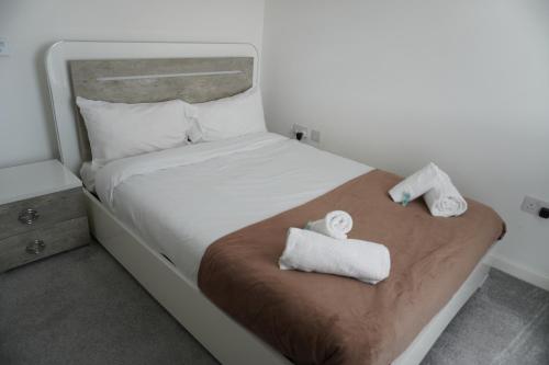 a bedroom with a bed with towels on it at Detached Home in Bishopton in Bishopton