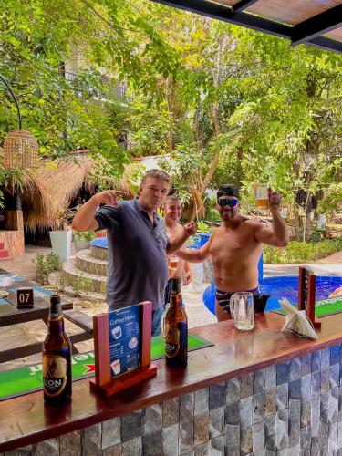 a group of men standing at a table with beer at Sundaras Resort LTD in Dambulla
