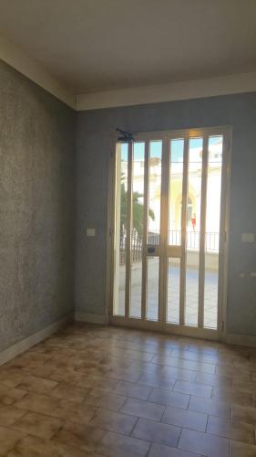 an empty room with sliding glass doors and a patio at Soffio Marino in Polignano a Mare