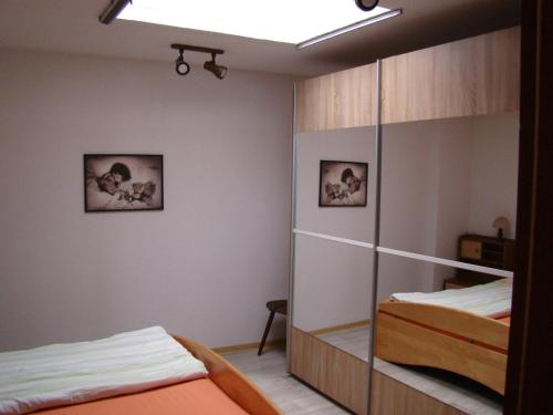 a bedroom with two beds and a mirrored closet at Ferienwohnung Heidi in Altena
