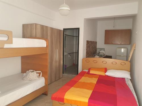 a bedroom with a bunk bed with a colorful blanket at Room zero of Sea in Borsh