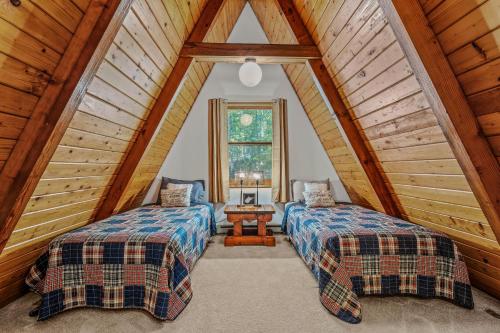 a bedroom with two beds in a attic at Cozy - Experience It All in Berkeley Springs