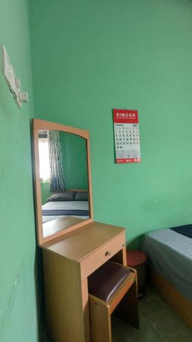 a mirror sitting on a desk in a bedroom at Gishi's Happy Stay - Galle in Galle