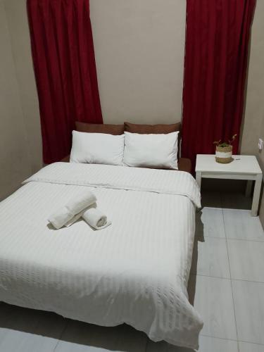 a bedroom with a bed with a towel on it at Surya homestay in Batukaras
