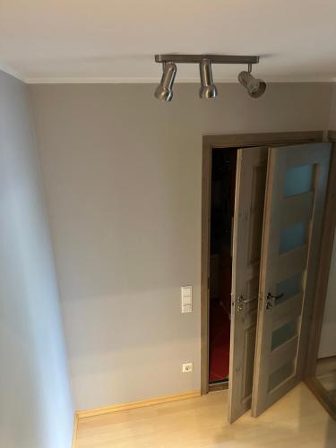 an empty room with a door and lights on the ceiling at MAjAKA in Tallinn