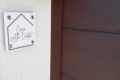 a door with a sign that says over the door at Casa Alla Veduta in Trento