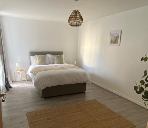 a bedroom with a bed and a pendant light at Apartment 15 in Larne